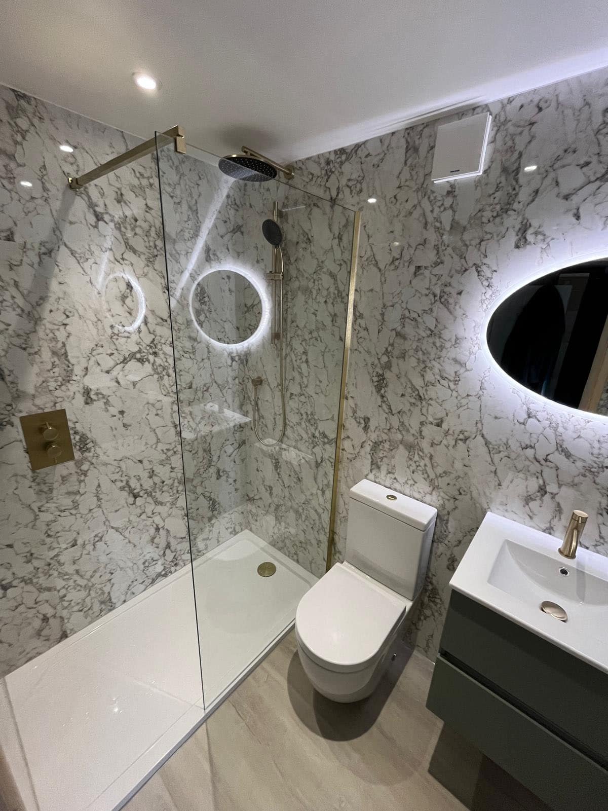 Gallery Ensuite bathroom with walk-in shower, toilet, vanity unit and illuminated mirror
