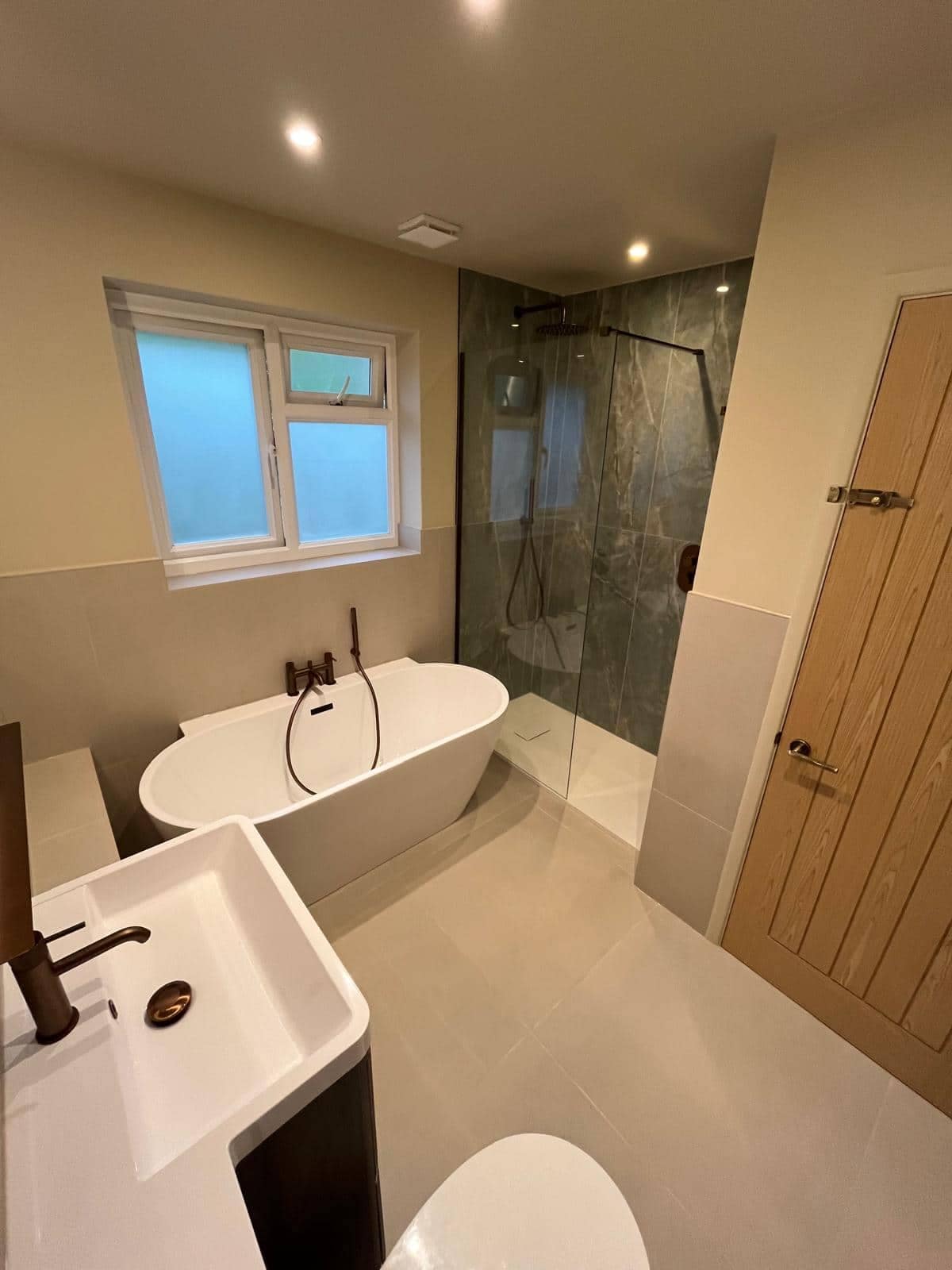 Home Overview of renovated bathroom in Gloucester with sink, bathtub and walk-in shower